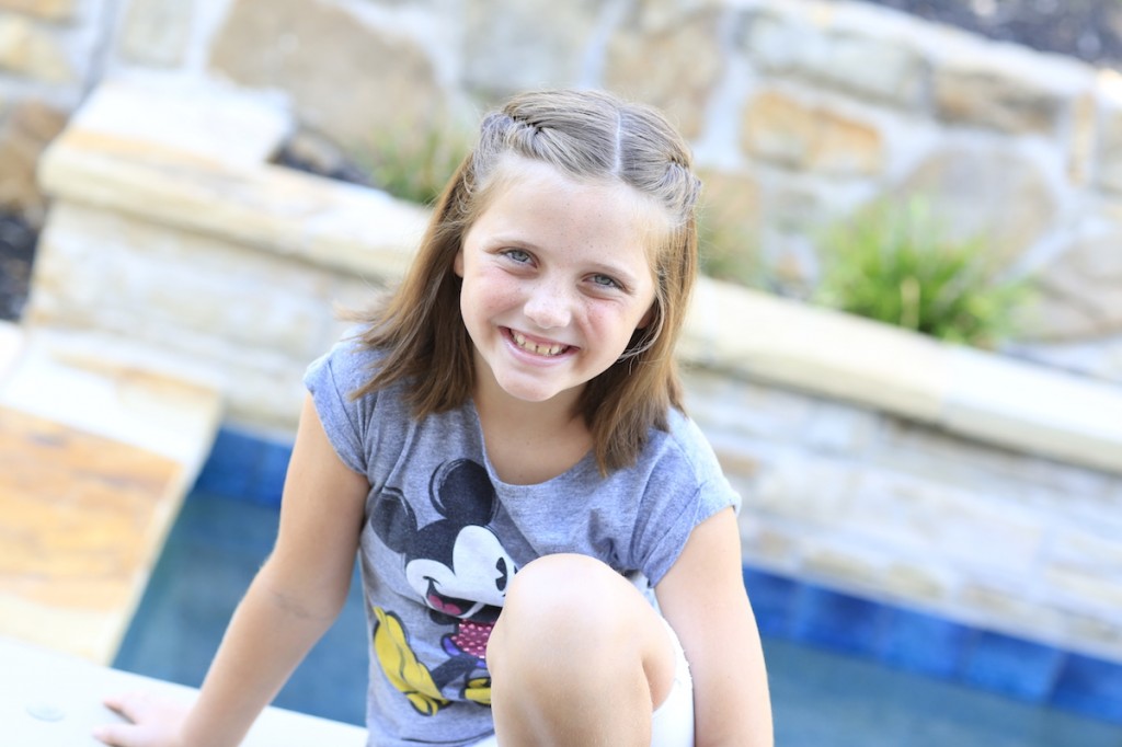 Little girl sitting by the pool modeling Laced Fishtail Tieback