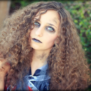 Young girl wearing Zombie Cheerleader costume | Halloween Hairstyles