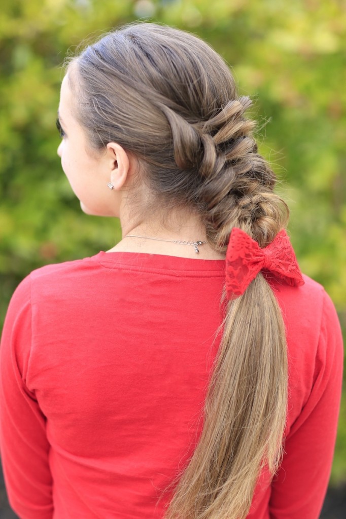 Young girl wearing a red shirt modeling Banded Puff Braid