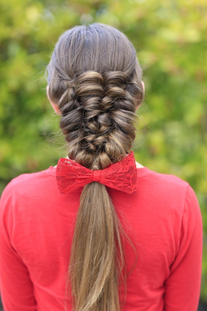 Young girl wearing a red shirt modeling Banded Puff Braid