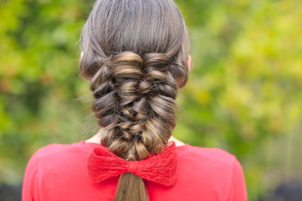 Young girl wearing a red shirt modeling Banded Puff Braid