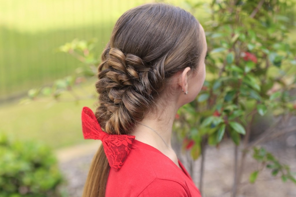 Young girl wearing a red shirt modeling Banded Puff Braid