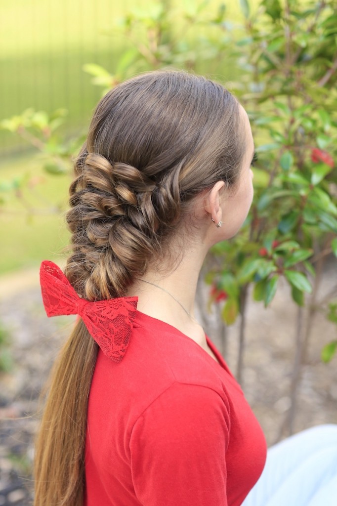 Young girl wearing a red shirt modeling Banded Puff Braid