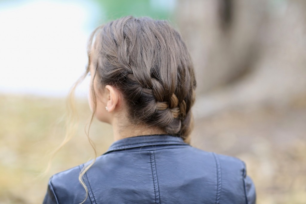 Girl outside wearing a back jacket modeling Katniss' Mockingjay Braid | Hunger Games Hairstyles (Back)