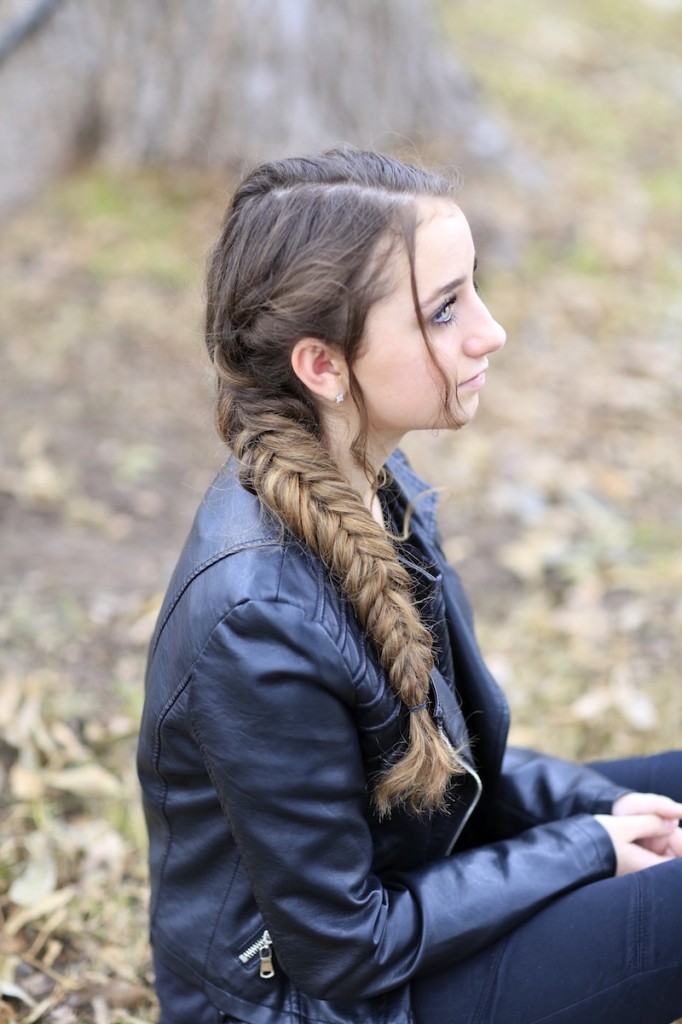 Girl outside wearing a back jacket modeling Katniss' Mockingjay Braid | Hunger Games Hairstyles