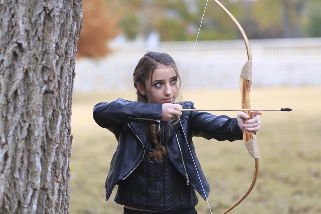 Girl outside wearing a back jacket modeling Katniss' Mockingjay Braid | Hunger Games Hairstyles
