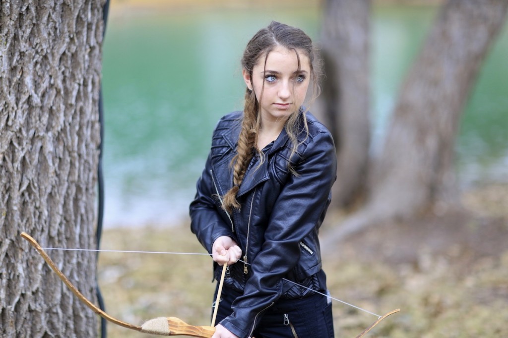 Girl outside wearing a back jacket modeling Katniss' Mockingjay Braid | Hunger Games Hairstyles