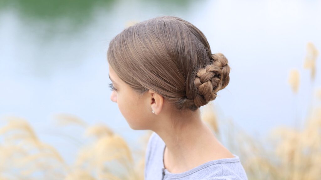 Young girl outside modeling Prim's Braided Updo | Hunger Games Hairstyles