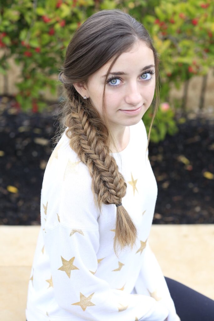 Young girl outside modeling Messy Split Fishtail Braid