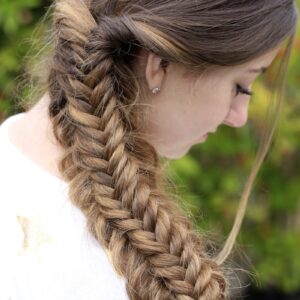 Young girl outside wearing a white shirt modeling Messy Split Fishtail Braid