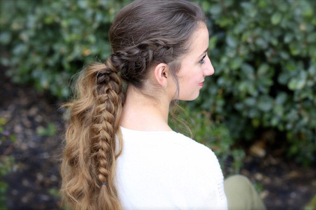 Young girl outside wearing a white shirt modeling Viking Braid Ponytail | Ponytail Ideas