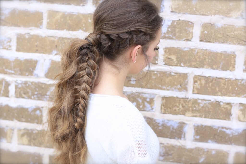 Young girl outside wearing a white shirt modeling Viking Braid Ponytail | Ponytail Ideas