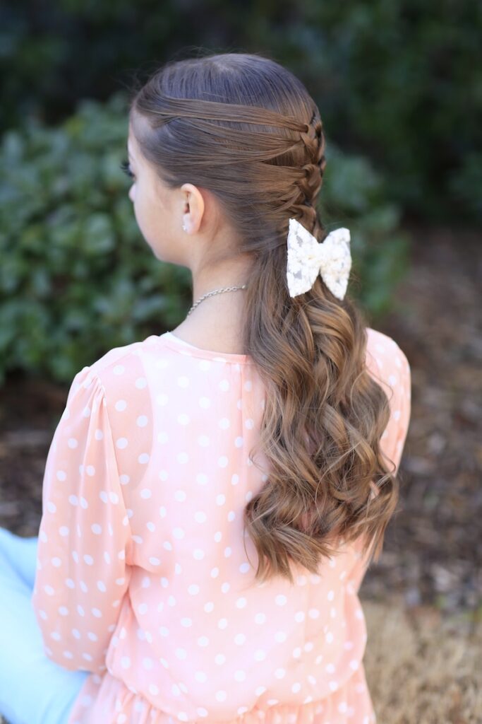 Young girl standing outside modeling Mermaid Heart Braid | Cute Valentine's Day Hairstyles