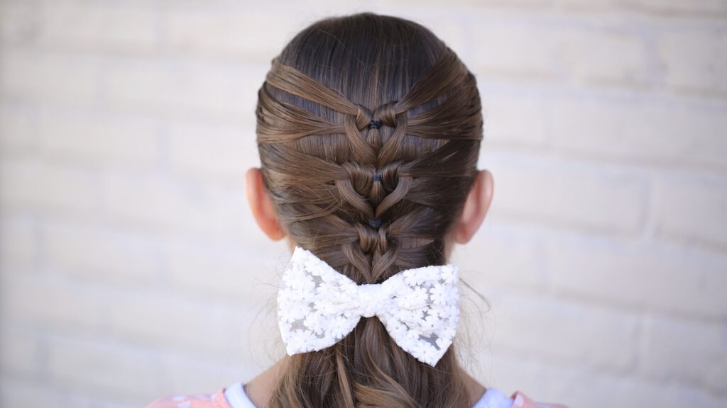 Young girl standing outside modeling Mermaid Heart Braid | Cute Valentine's Day Hairstyles