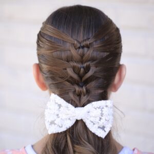 Young girl standing outside modeling Mermaid Heart Braid | Cute Valentine's Day Hairstyles (Back)