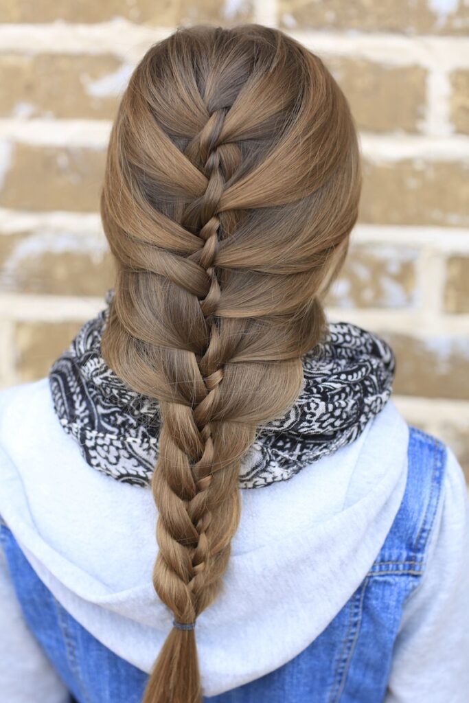 Young girl outside modeling Waterfall Twist & Mermaid Braid Combo (back)