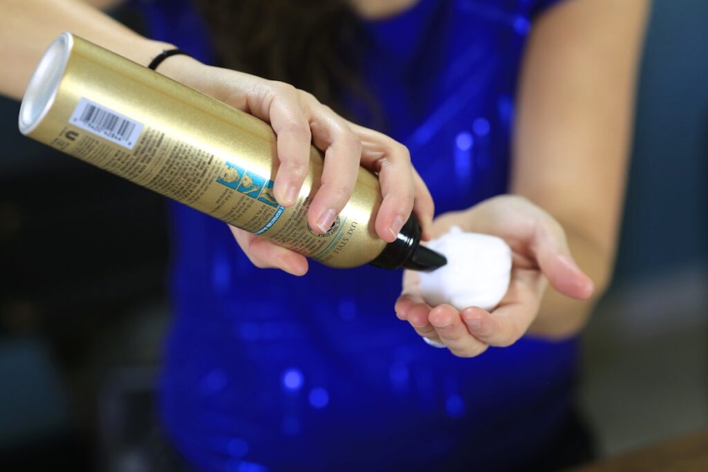 Diffused Curls | Woman putting hair products into her hand