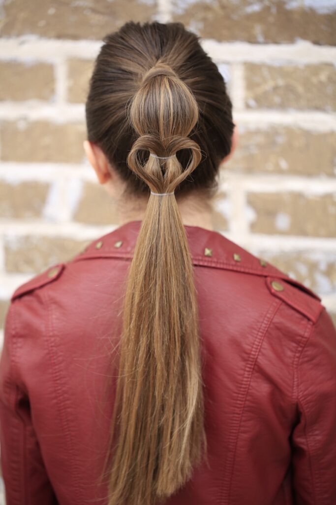 Young girl standing outside modeling Heart Ponytail | Valentine's Day Hairstyles