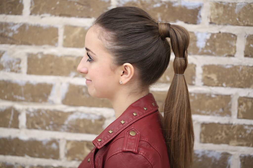 Young girl standing outside modeling Heart Ponytail | Valentine's Day Hairstyles