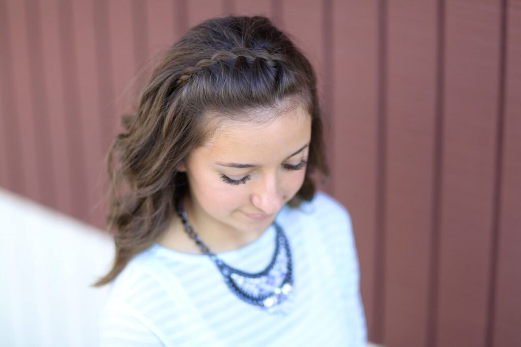 Young girl outside modeling DIY Faux Waterfall Headband