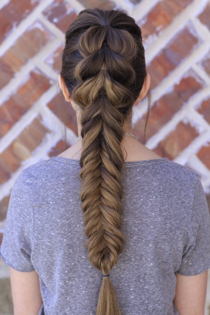 Young girl outside modeling the Pull-Through Fishtail Braid Combo
