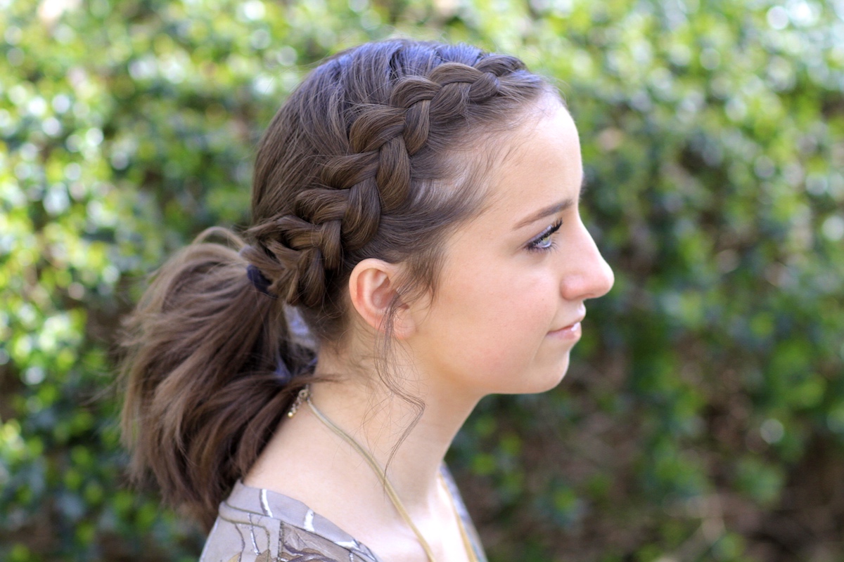 Portrait of young girl outside modeling Dutch Accent Ponytail Short Hairsty...
