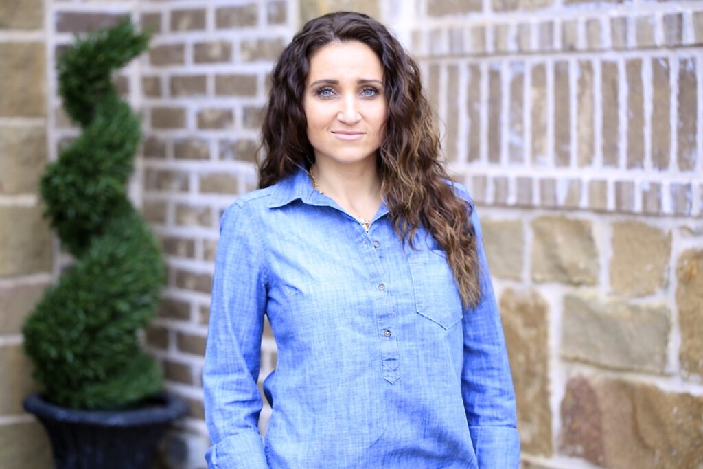 Woman standing outside modeling Boxer Braids No-Heat Curls