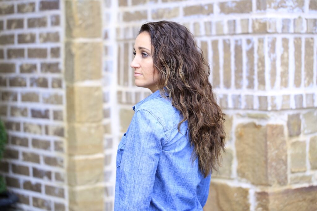 Woman standing outside modeling Boxer Braids No-Heat Curls