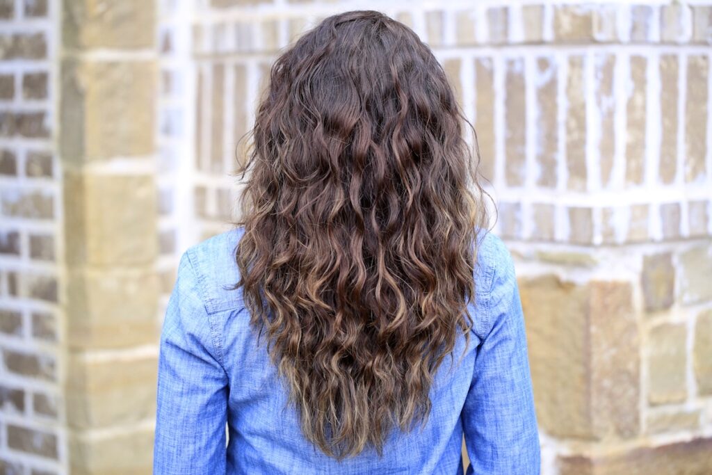 Woman standing outside modeling Boxer Braids No-Heat Curls