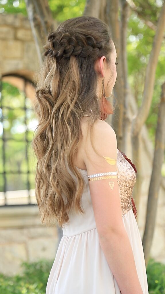 Back view of girl with long hair standing outside modeling "Braided Half Up"