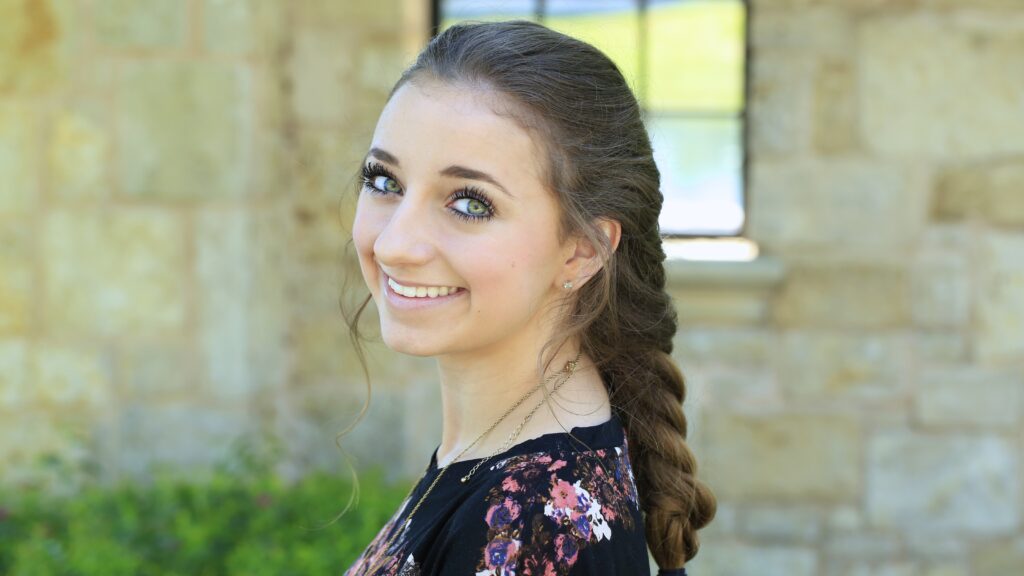 Young girl outside modeling Faux French Braid