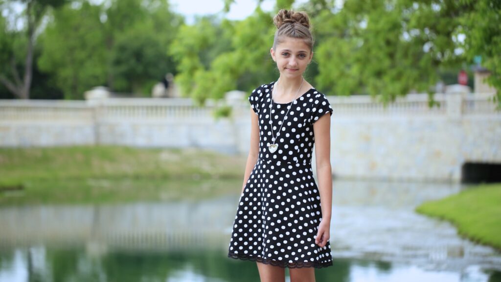 Young girl outside by the lake modeling Double French Braid High Bun Updo