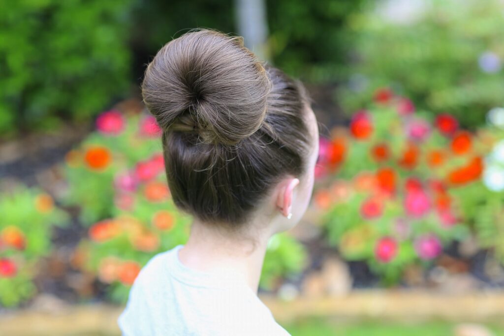 Portrait of a young girl modeling The Fan Bun | Prom Updos (Back)