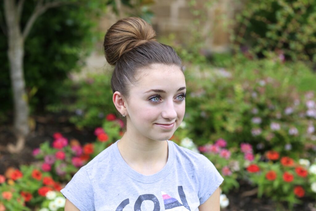 Portrait of a young girl modeling The Fan Bun | Prom Updos