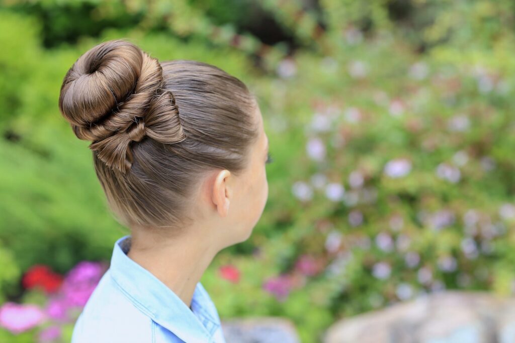 Young girl outside modeling Bow Bun Updo