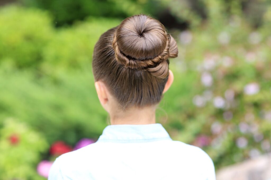 Young girl outside modeling Bow Bun Updo (Back)