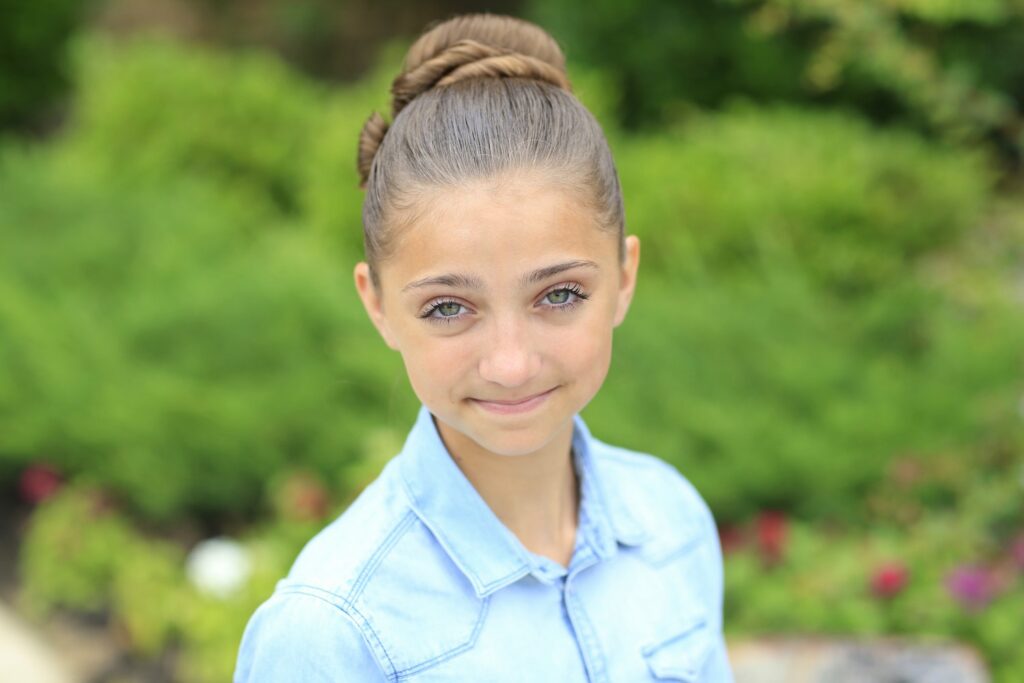 Young girl outside modeling Bow Bun Updo