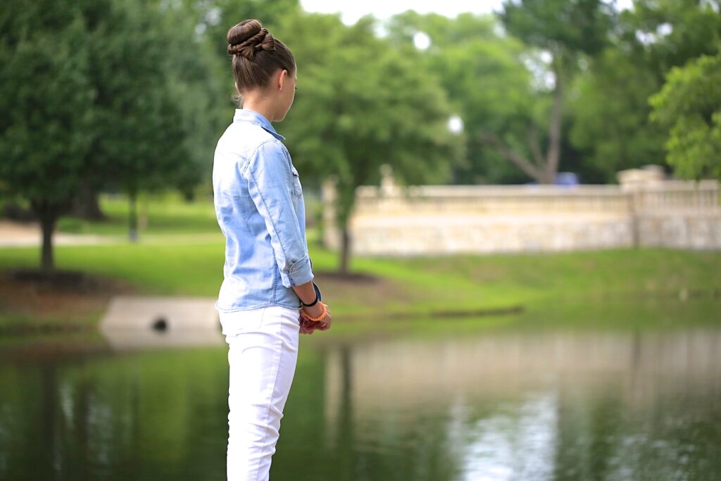 Young girl outside standing from the lake