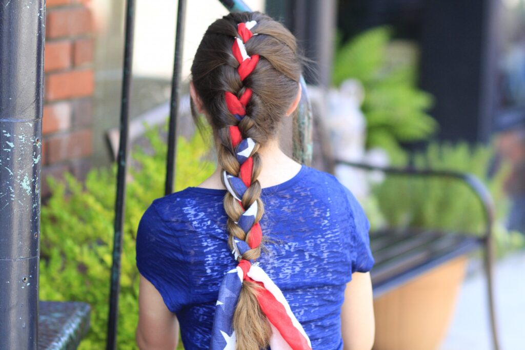 Young girl outside modeling 3-Minute Scarf Braid | 4th of July Hairstyles (Back)