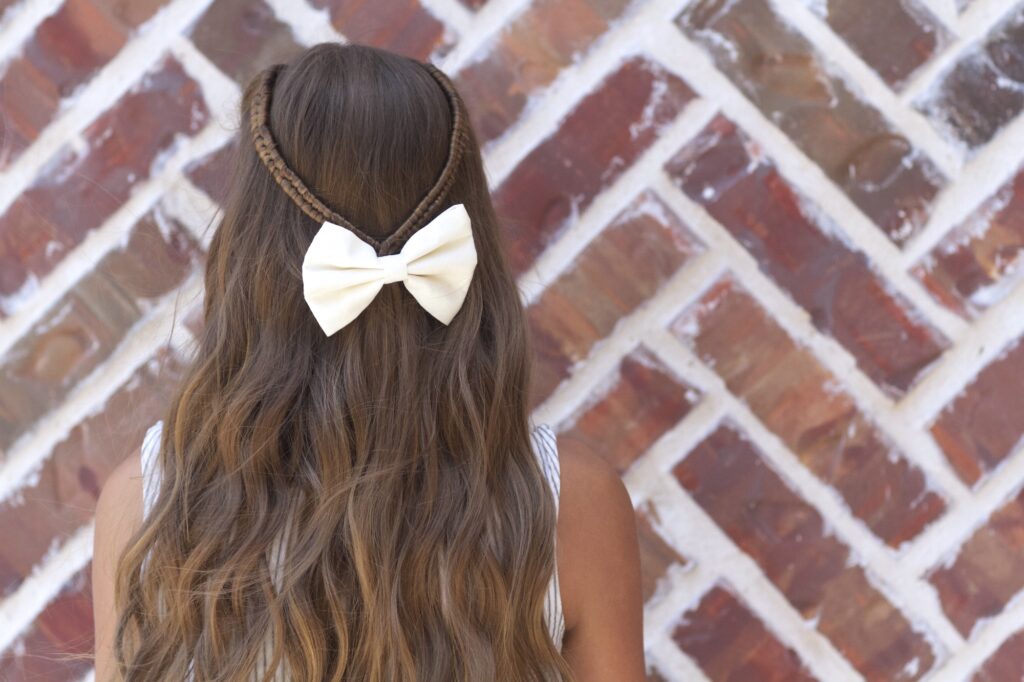 Young girl outside modeling Infinity Braid Tieback | Back-to-School Hairstyles (Back)