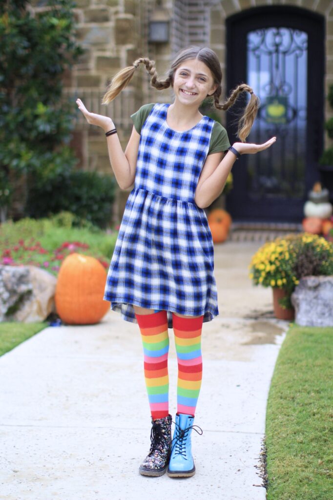 Young girl outside modeling Pippi Longstock Braids | Easy Halloween Hairstyles