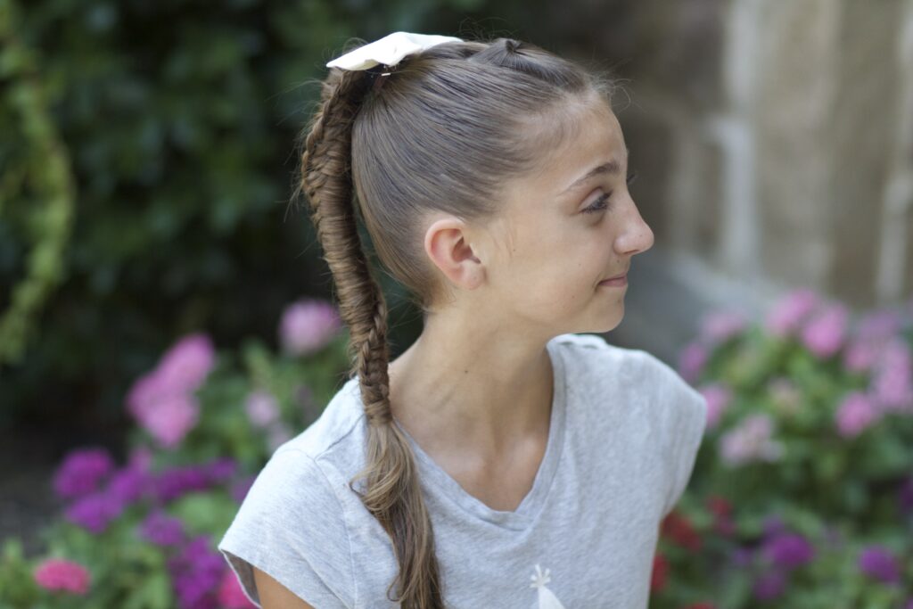 Young girl outside modeling Chinese Staircase Braid