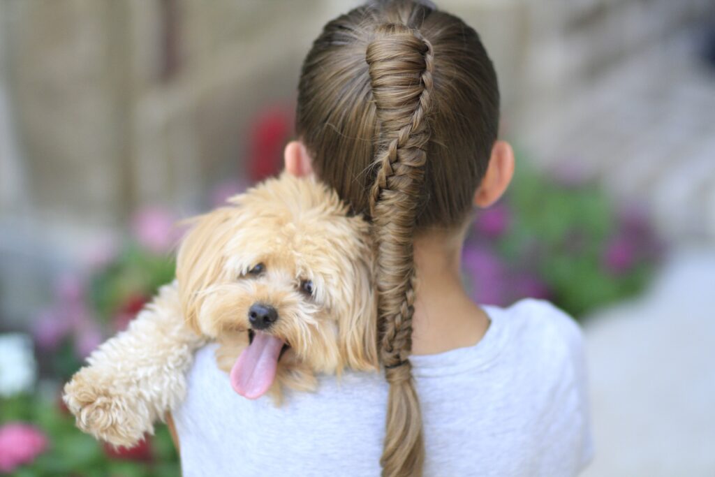 Young girl outside modeling Chinese Staircase Braid (back) 