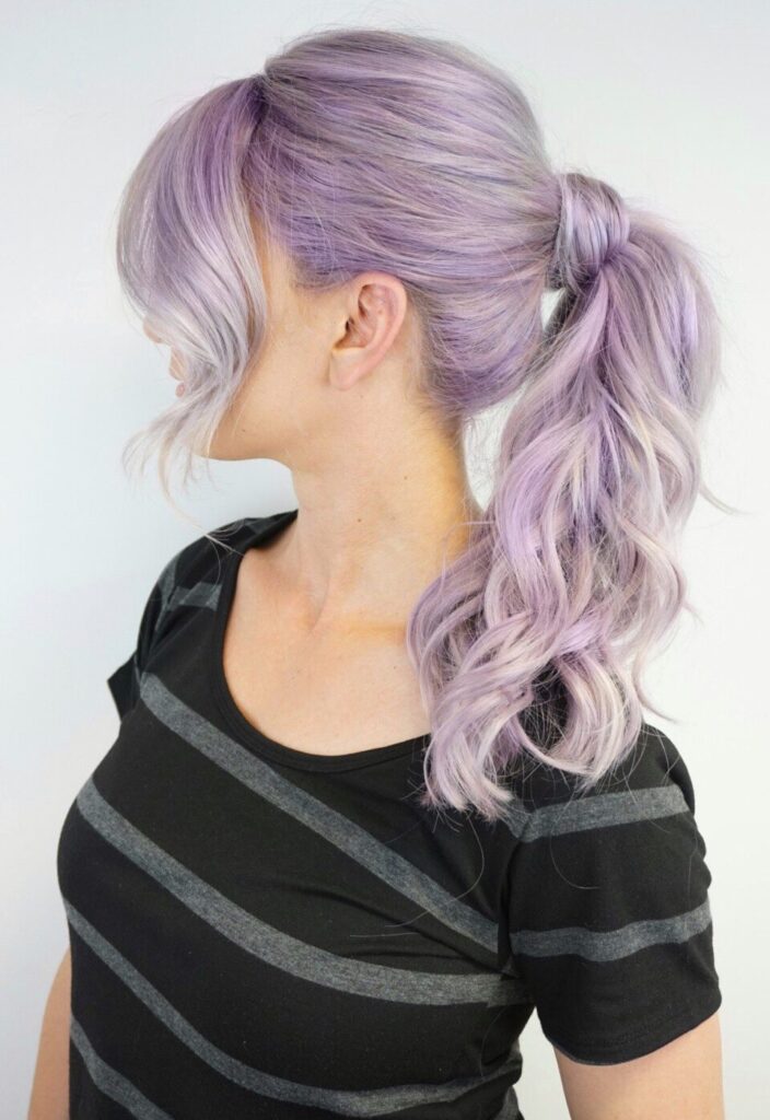 Profile Side view of girl with lavender modeling a high ponytail in front of a white background