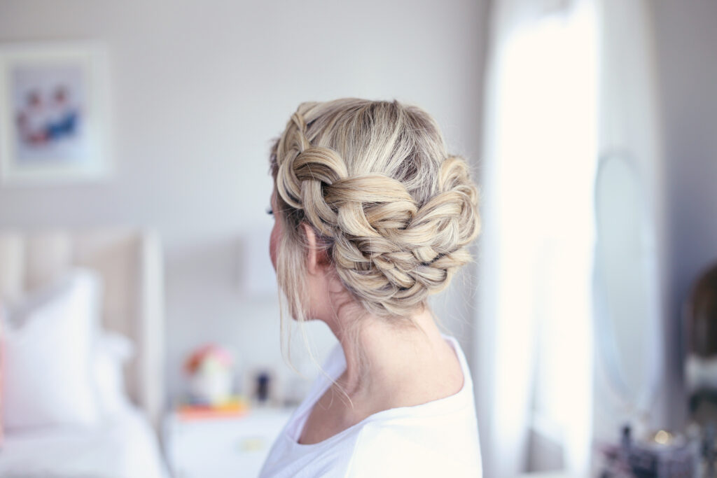 Profile side view of young women standing in her room modeling "Crown Braid" hairstyle