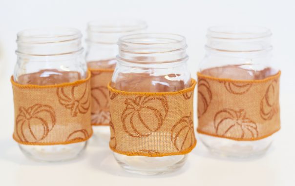Mason jars wrapped with fall themed ribbon