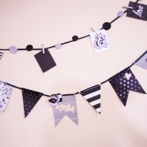 Cute black and white paper banner hanging on a white wall