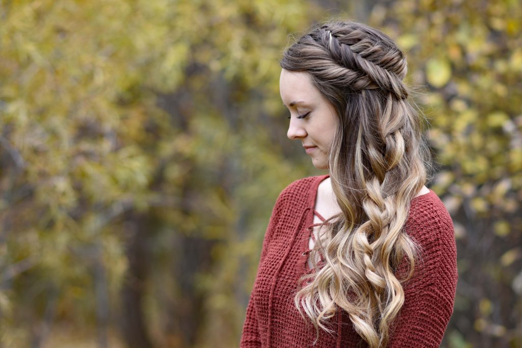 Side view of girl wearing red shirt outside modeling "Side Swept Fishtail" hairstyle