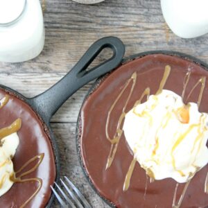 Texas Sheet Cake in mini skillets placed on a wooden table