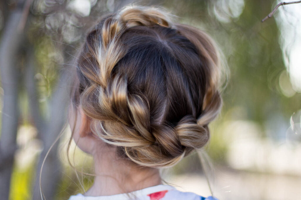 Close up back view of young girl outside modeling "Pull-Thru Crown Braid" hairstyle